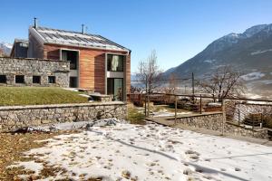 a house with snow on the ground in front of it at La Maison du Renard in Sarre