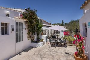 a patio with a table and chairs and flowers at Can Vital 2 in Illes Balears