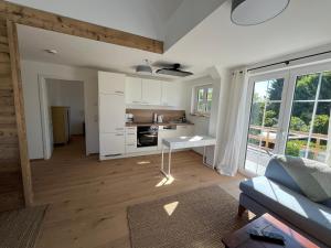 a kitchen and living room with a couch and a table at Landhausloft in Bermatingen +19 photos