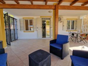 a living room with a blue chair and a table at Casa Flavia in Nebida