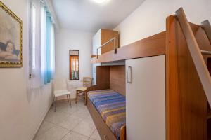 a small room with a bunk bed and a staircase at Casa Flavia in Nebida