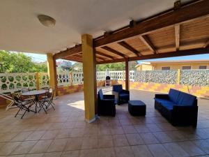 a patio with blue chairs and a table on a patio at Casa Flavia in Nebida