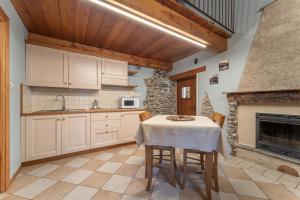 a kitchen with a table and a fireplace at Civico 5 in Marmora
