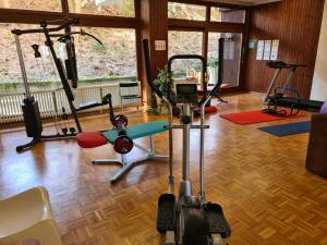 a gym with several exercise equipment in a room at Schwarzwald Heimat mit Pool, Sauna in Schönwald