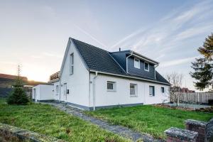 a white house with a black roof at Haus Primavera in Bad Bentheim