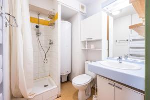 a white bathroom with a sink and a toilet at Appartement 'Bds1 37' 5 Couchage in Saint-François-Longchamp +14 photos