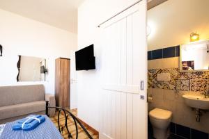 a small bathroom with a toilet and a sink at Villa Gaudì - Sagrada in Sant'Isidoro +23 photos