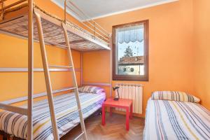 a bedroom with two bunk beds and a window at Da Roby - Villa Carolina in Fenis