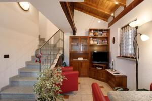 a living room with a staircase and a red couch at Da Manu - Blavy Nus in Blavy
