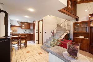 a kitchen and dining room with a staircase in a house at Da Manu - Blavy Nus in Blavy