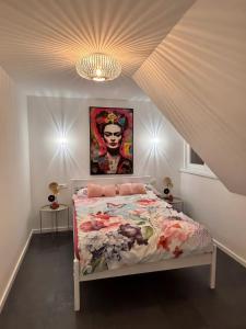 a bedroom with a bed with a painting on the wall at Ferienhaus Lopezan House, Living in Hornberg