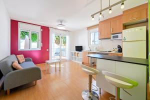 a kitchen and living room with a couch and a table at Dorada Apartment Mar in Calafell