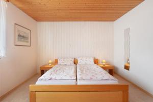 a bedroom with a bed and two night stands at Ferienwohnung Rehm in Bad Säckingen