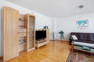a living room with a couch and a television at Ferienwohnung Rehm in Bad Säckingen