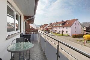 a balcony with a table and a view of a street at Ferienwohnung Rehm in Bad Säckingen