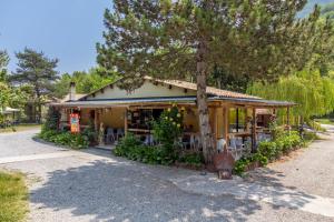 a building with a tree in front of it at Roulotte insolite terrasse nature in Touët-sur-Var +7 photos