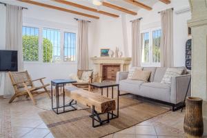a living room with a couch and a fireplace at Villa Del Sol - Solo Familias 1819 in Jávea