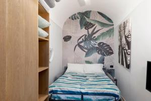 a bedroom with a bed and a wall with a mural at Magia e Luce in Sanremo