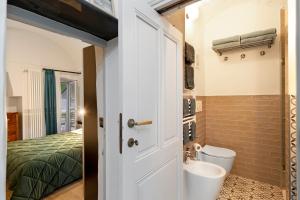 a bathroom with a sink and a toilet and a bed at Magia e Luce in Sanremo +25 photos