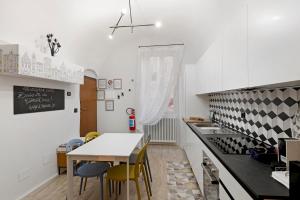 a kitchen with a table and a dining room at Magia e Luce in Sanremo
