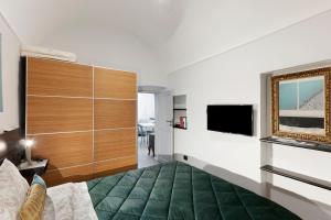 a bedroom with a bed and a flat screen tv at Magia e Luce in Sanremo