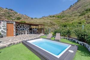 a swimming pool in the yard of a house at Casa Abuela Fela in Vega de San Mateo