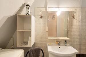 a bathroom with a sink and a toilet at Le Vigan, balcon, parking, animaux in Le Vigan +28 photos
