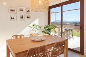 a dining room with a wooden table and chairs at Son Rossinyol Nou - Ses Figueretes in Islas Baleares