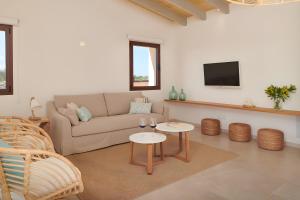 a living room with a couch and two tables at Son Rossinyol Nou - Ses Figueretes in Islas Baleares