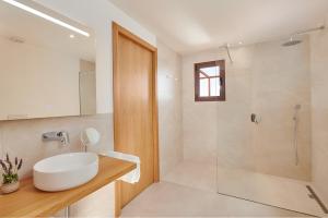a bathroom with a white sink and a shower at Son Rossinyol Nou - Ses Figueretes in Islas Baleares +10 photos