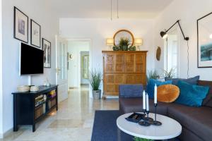 a living room with a couch and a table at Penthouse Victoria in Fuengirola