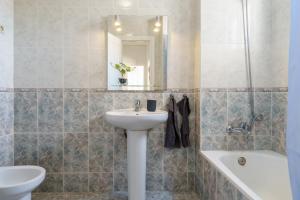 a bathroom with a sink and a toilet and a tub at Penthouse Victoria in Fuengirola +17 photos