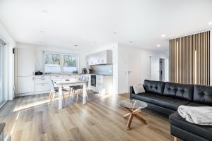 a living room with a black couch and a table at Haus Luise in Bramstedtlund