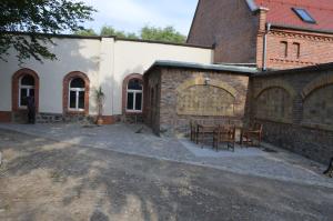 an outdoor patio with a table and a building at Campingfass Bunge 1 in Krostitz