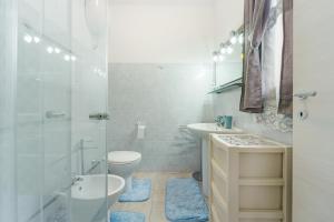 a bathroom with a toilet and a sink and a shower at Casa Vacanza Da Gabry in Perdaxius