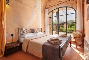 a bedroom with a bed and a large window at Son Garreta in El Palmer +31 photos