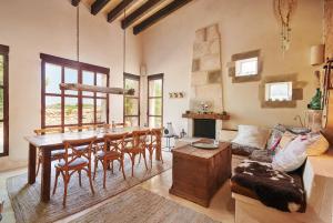 a living room with a table and chairs and a couch at Son Garreta in El Palmer