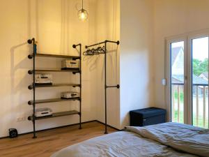 a bedroom with a bed and a book shelf at Ferienhaus Riedlodge Bodensee-Obers in Guggenhausen