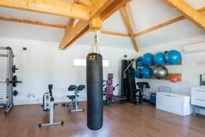a gym with a punching bag in a room with exercise equipment at Camping Les Oyats in Seignosse
