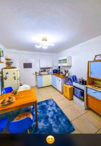 a kitchen with a table and a tv in it at Am Weinberg Kassel Gästezimmer in Kassel
