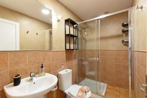 a bathroom with a toilet and a sink and a shower at Vv Faro in Puerto de Mogán +17 photos