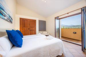 a bedroom with a white bed and a large window at El Olivar in El Port de la Selva +26 photos