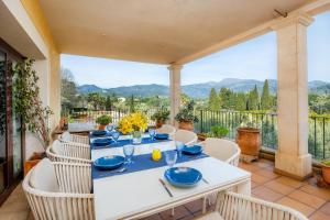 a white table and chairs on a patio at El Olivar in El Port de la Selva