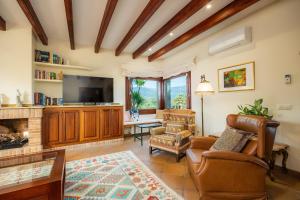 a living room with a couch and a fireplace at El Olivar in El Port de la Selva