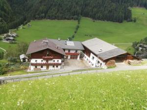 an aerial view of a large house in a field at Oberhöher Apt Talblick in San Pietro