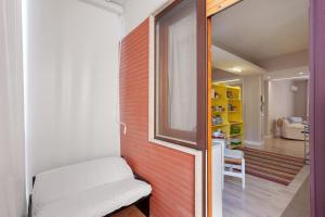 a room with a brick wall with a white bench at Casa Frank 2 in Torre Annunziata +28 photos