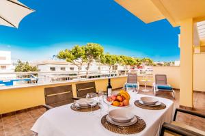 a table with a bowl of fruit on a balcony at Drac Blanc 1-3 in Cala Ratjada