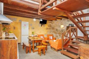 a kitchen and dining room with a wooden staircase and a table at Casa Emblemática La Pileta Bentejui in Agüimes +15 photos