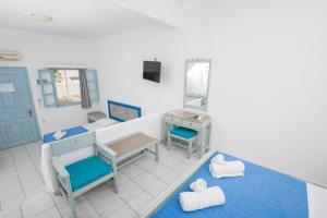 a room with a bed and a sink and a mirror at Pico Bello Patmos 12 in Patmos