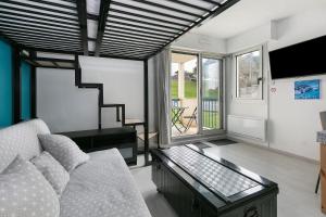 a living room with a couch and a table at Studio Emma in Le Croisic